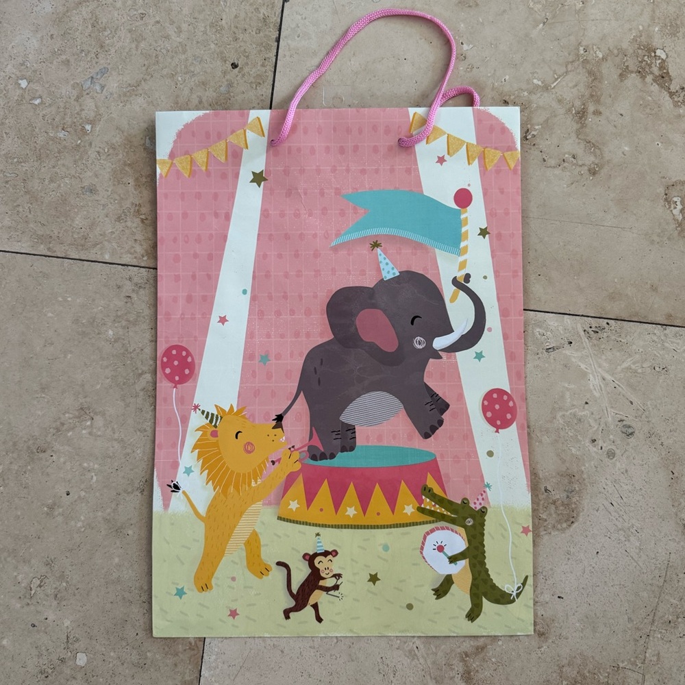 pink baby shower gift bag with circus scene